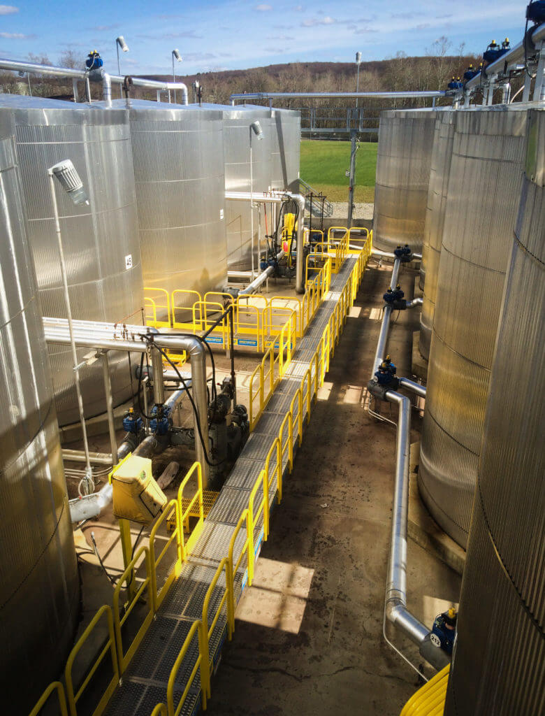 Erectastep industrial crossover stairs and access platform between tanks