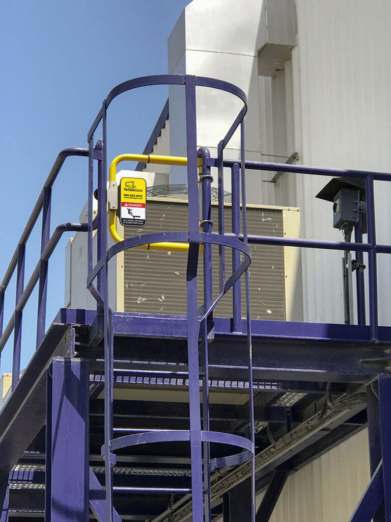 YellowGate placed on blue safety ladder for safe AC Unit access